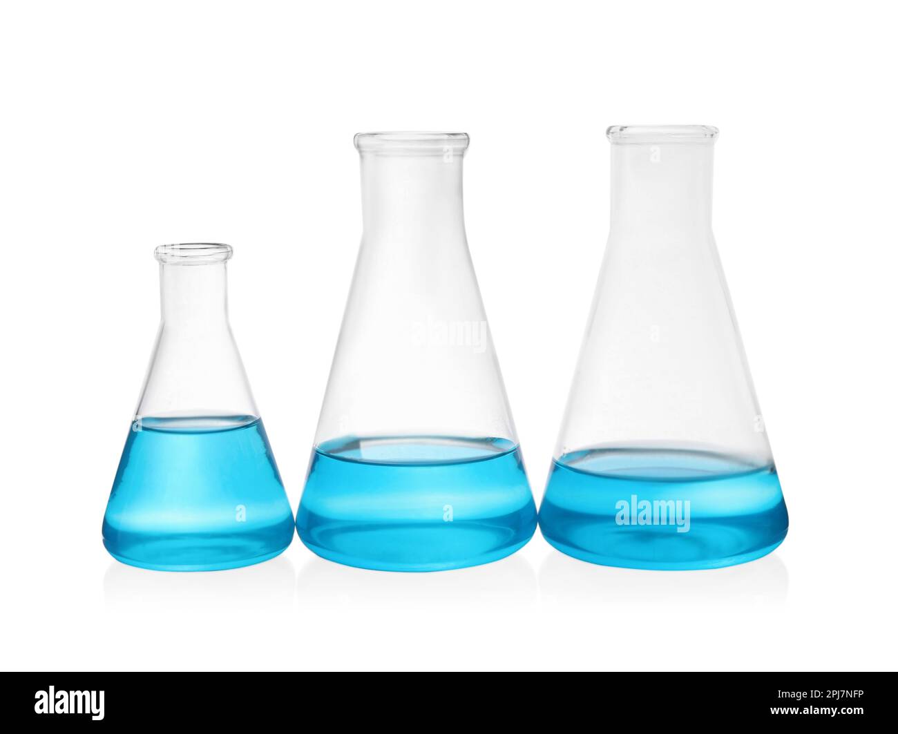 Different laboratory glassware with light blue liquid on white