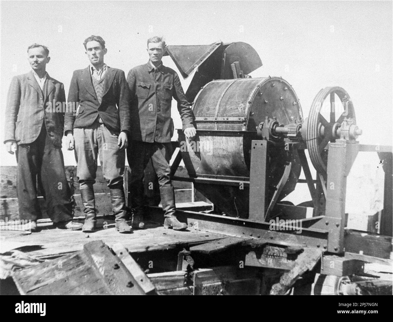 Former Sonderkommando 1005 slave laborers stand next to a bone crushing machine at the Janowska concentration camp (photo taken in August 1944, after camp's liberation) Stock Photo
