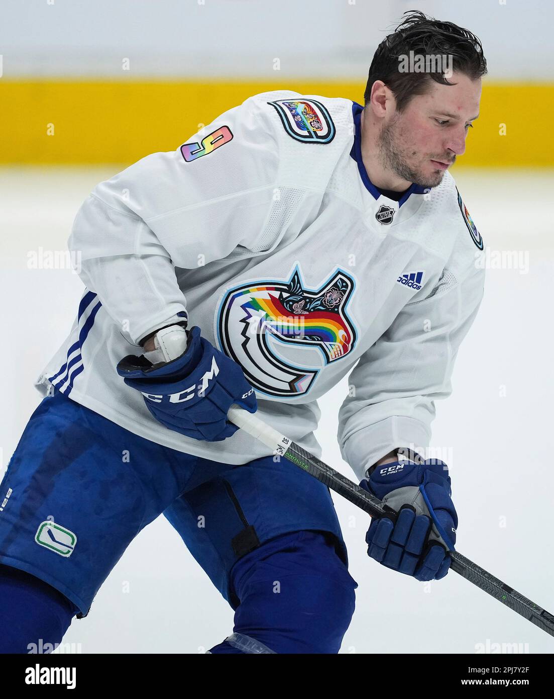 Vancouver Canucks' J.T. Miller wears a pride-themed warmup jersey