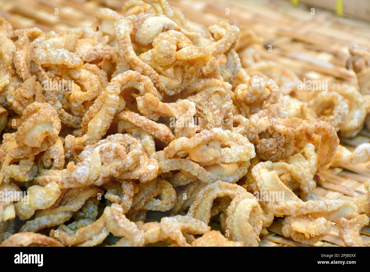 Thai street food, Pork rinds or deep fried pork skin, a yummy snack. Stock Photo