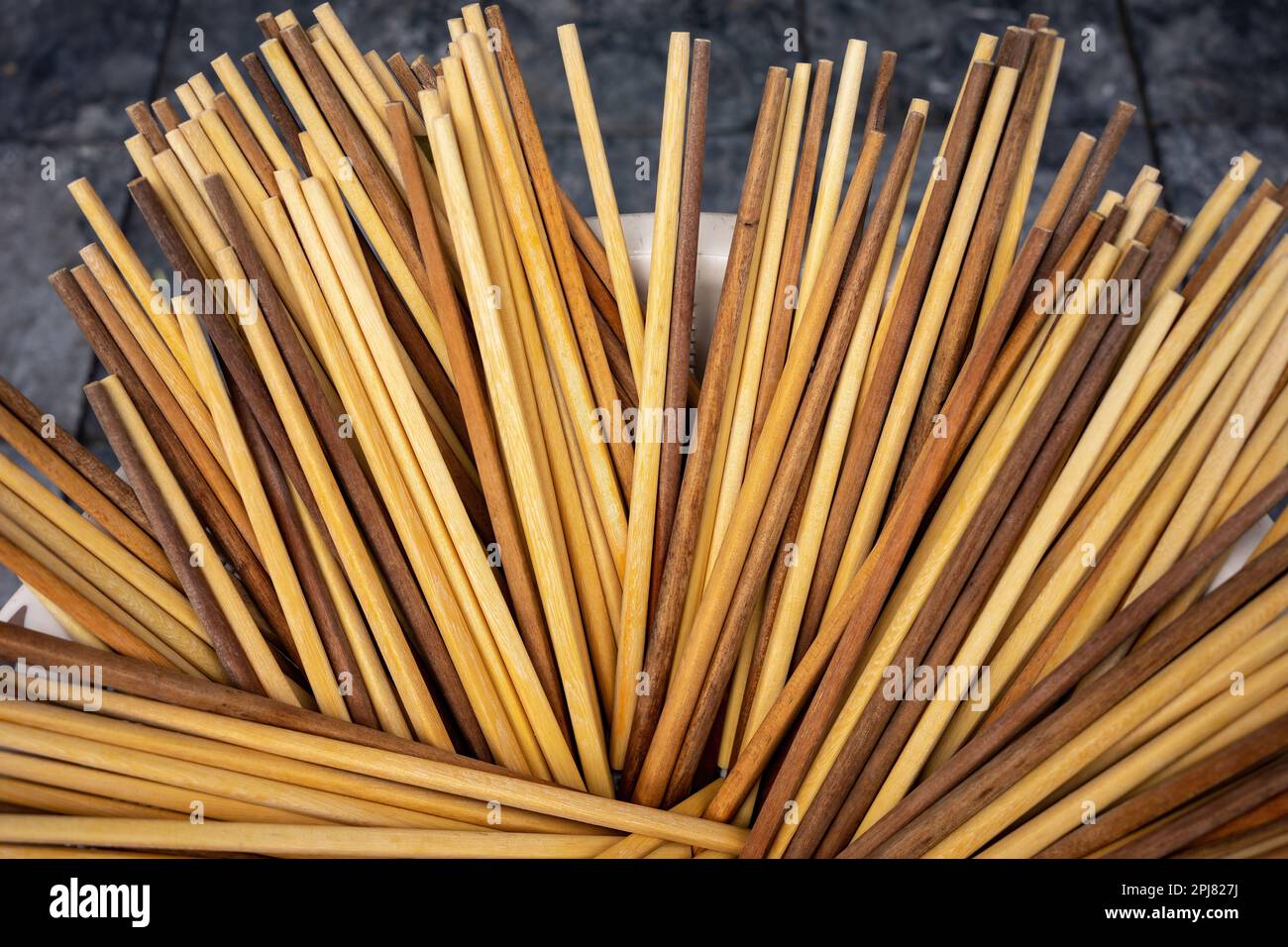 A bucket full of clean wooden chopsticks at a street stall in Hanoi