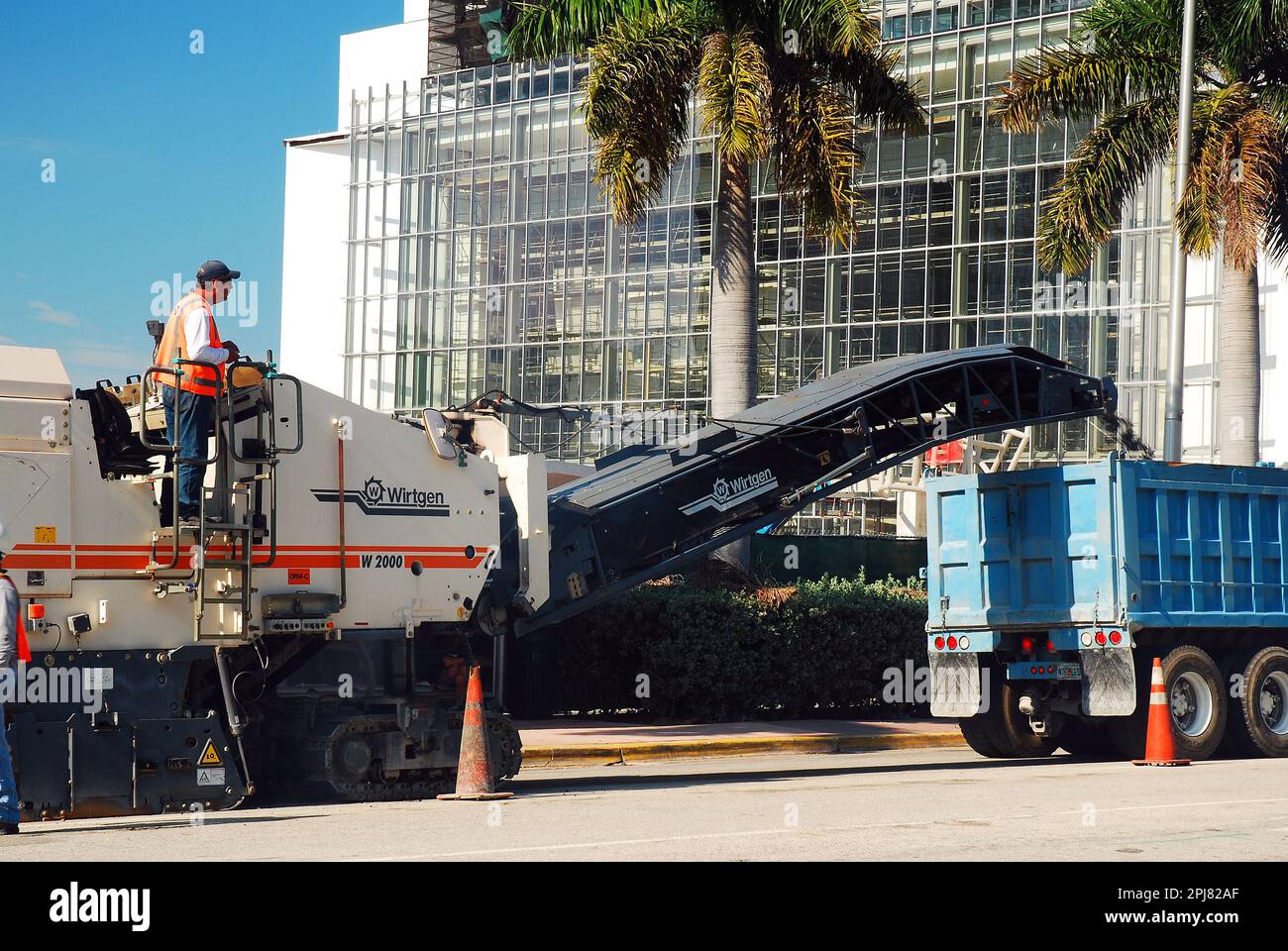 Construction workers use heavy equipment to repair and repave the city