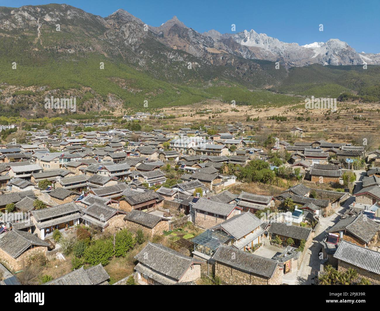 Remote village in Yunnan with snow mountain in background Stock Photo ...