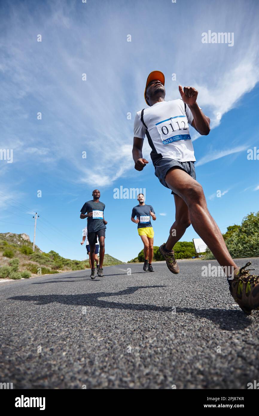 See you at the finish line. Low angle shot of a group of young men ...