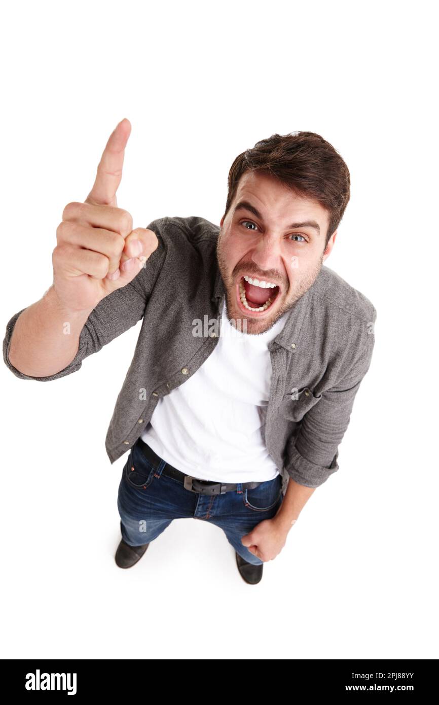 Make yourself heard. High-angle portrait of an angry young man in studio shaking his finger and shouting. Stock Photo