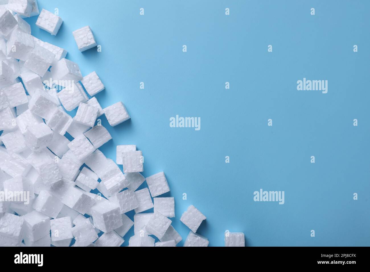 Many styrofoam cubes on light blue background, flat lay. Space for text Stock Photo