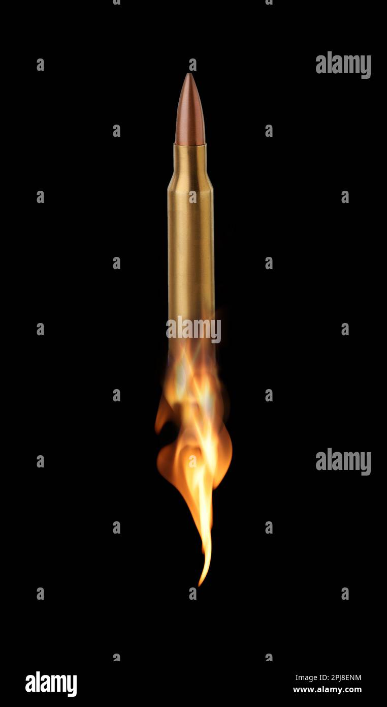 Bullet with flames flying on black background Stock Photo - Alamy