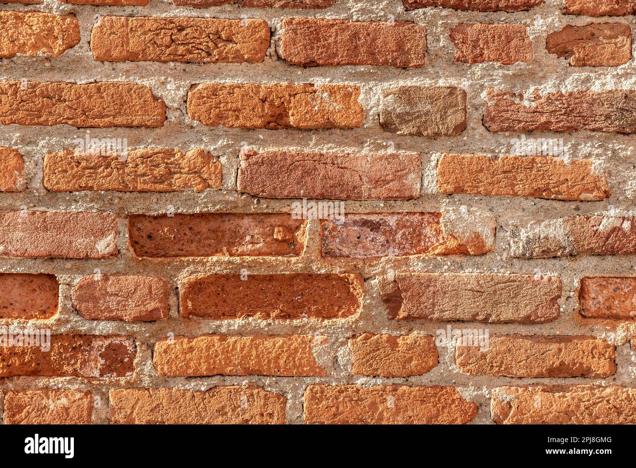 Wall made of red bricks, suitable as background or wallpaper pattern. Stock Photo