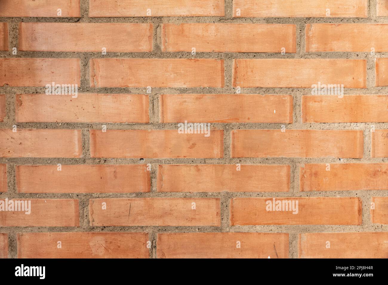 Wall made of red bricks, suitable as background or wallpaper pattern. Stock Photo