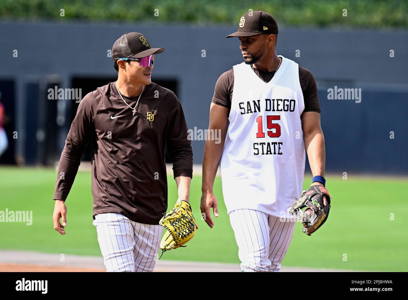 San Diego Padres' Ha-Seong Kim, left, talks with Xander Bogaerts walking  off the infield during warmups before a baseball game against the Colorado  Rockies in San Diego, Friday, March 31, 2023. (AP