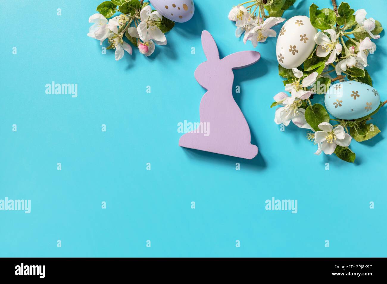 Easter composition with colorful eggs, wooden bunny and spring flowers ...