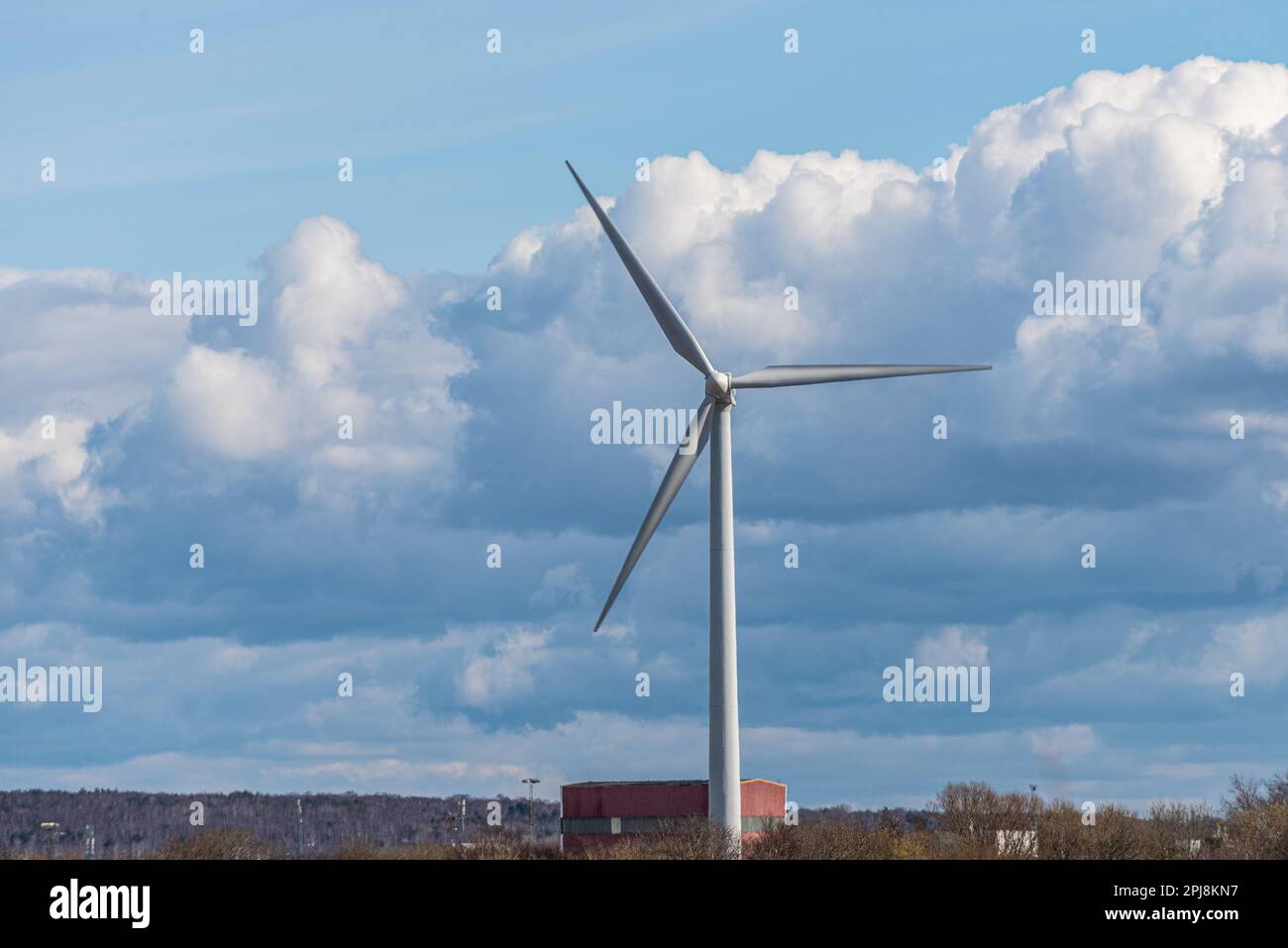 Wind turbine by industrial buildings Stock Photo Alamy