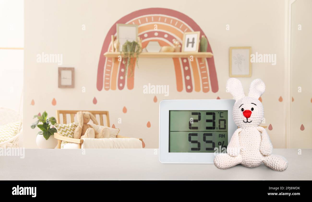 Digital hygrometer with thermometer on table in children's room