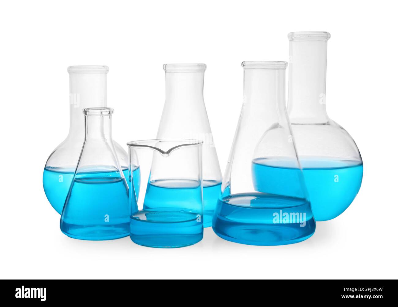 Different laboratory glassware with light blue liquid on white ...