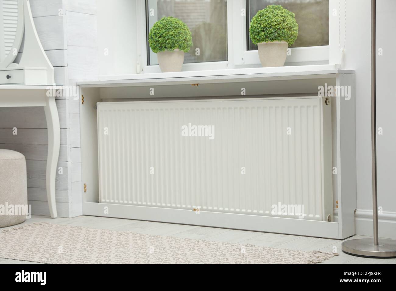 Modern radiator at home. Central heating system Stock Photo - Alamy