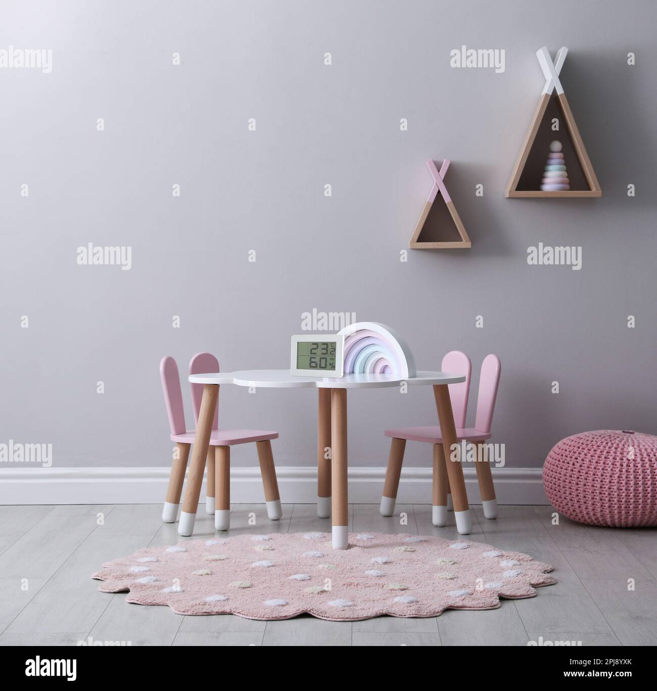 Digital hygrometer with thermometer on small table in children's room