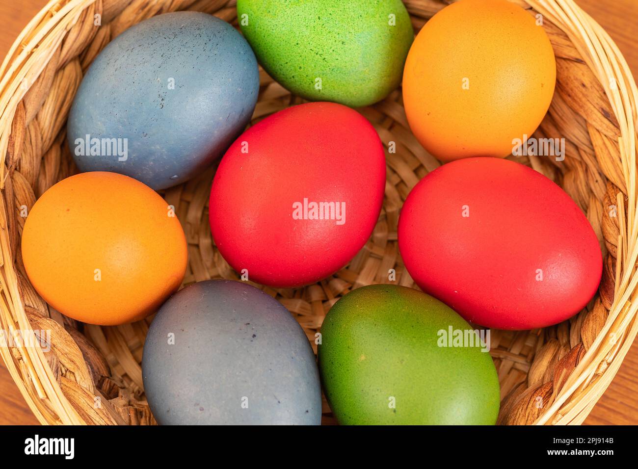 Easter eggs, dyed hen eggs in a wicker basket Stock Photo