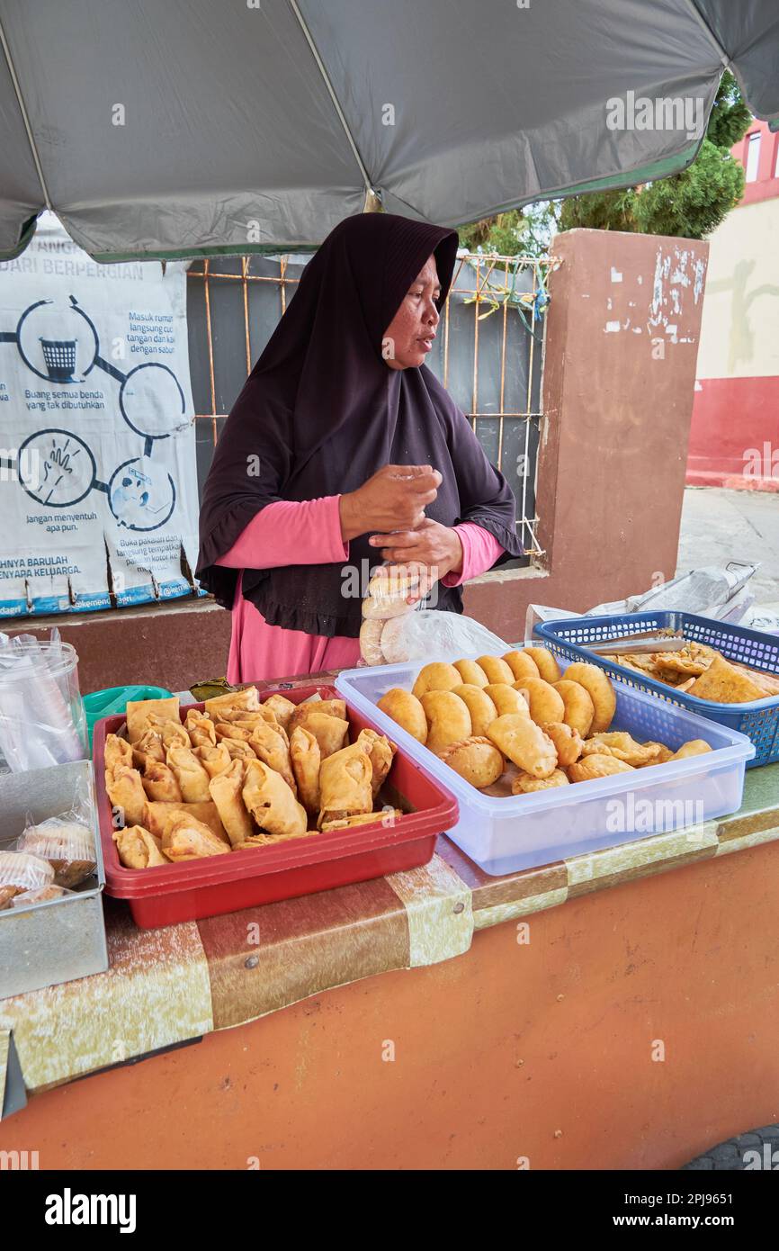 March, 2023. Depok, West Java, Indonesia. It's called takjil in Indonesia, food for breaking of the fast or iftar. A woman selling food for takjil dur Stock Photo