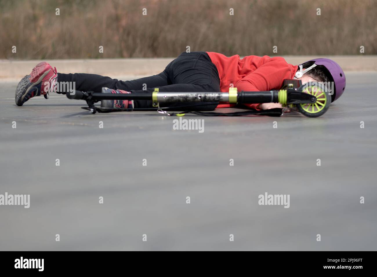 Little girl's tumble scooter accident on pavement Stock Photo Alamy
