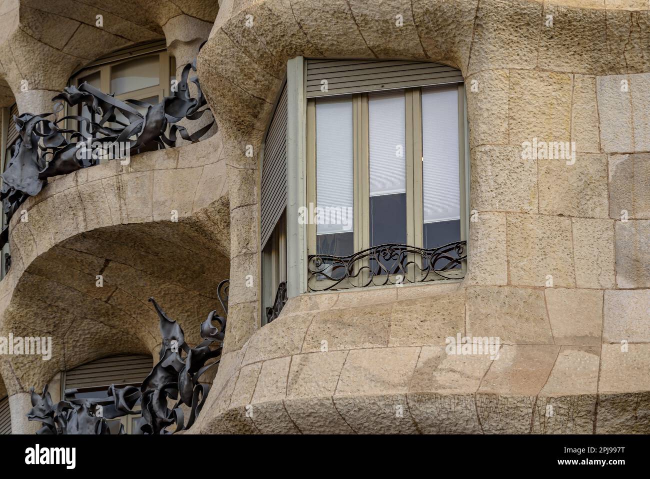 Detail of a window and the stone façade that gave the nickname of La Pedrera to Casa Milà (Barcelona, Catalonia, Spain) Stock Photo