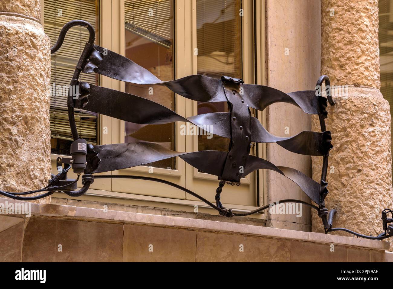 Detail of a wrought iron railing and window in one of the interior ...