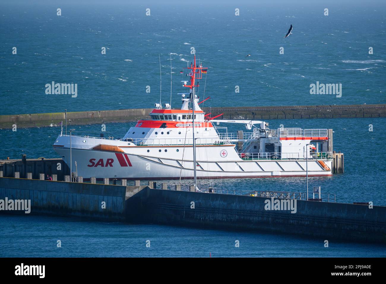 24 March 2023, Schleswig-Holstein, Helgoland: The rescue cruiser Hermann Marwede of the German Maritime Search and Rescue Service (DGzRS) is moored in the harbor of the deep-sea island of Helgoland. Photo: Jonas Walzberg/dpa Stock Photo
