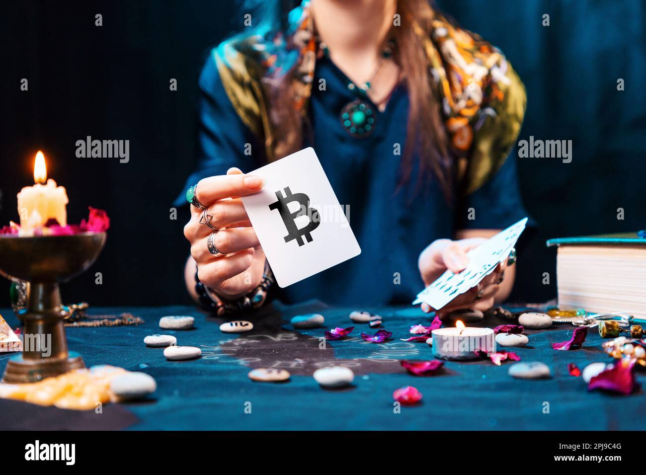 The fortune teller shows a card with the bitcoin currency, and sets it on  fire from the candle flame. The concept of unpredictable Cryptocurrency  Exch Stock Photo - Alamy