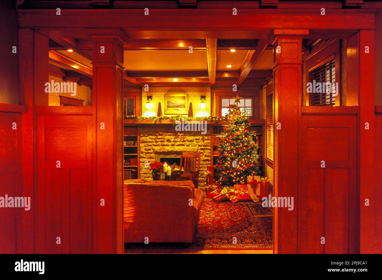 CRAFTSMAN HOME DOORWAY INTO LIVING ROOM INTERIOR WITH CHRISTMAS TREE Stock Photo