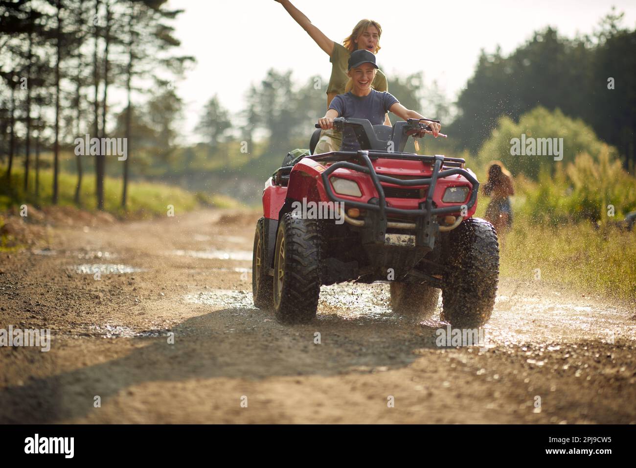 Extreme young girls ride quads on a road in the nature Stock Photo Alamy