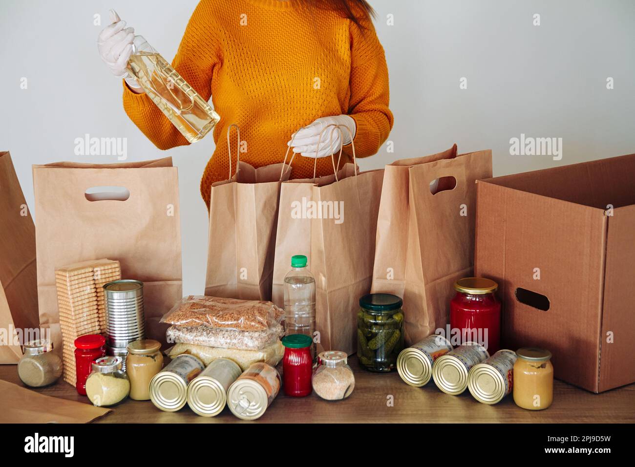 woman in medical gloves packing food for donation Stock Photo - Alamy