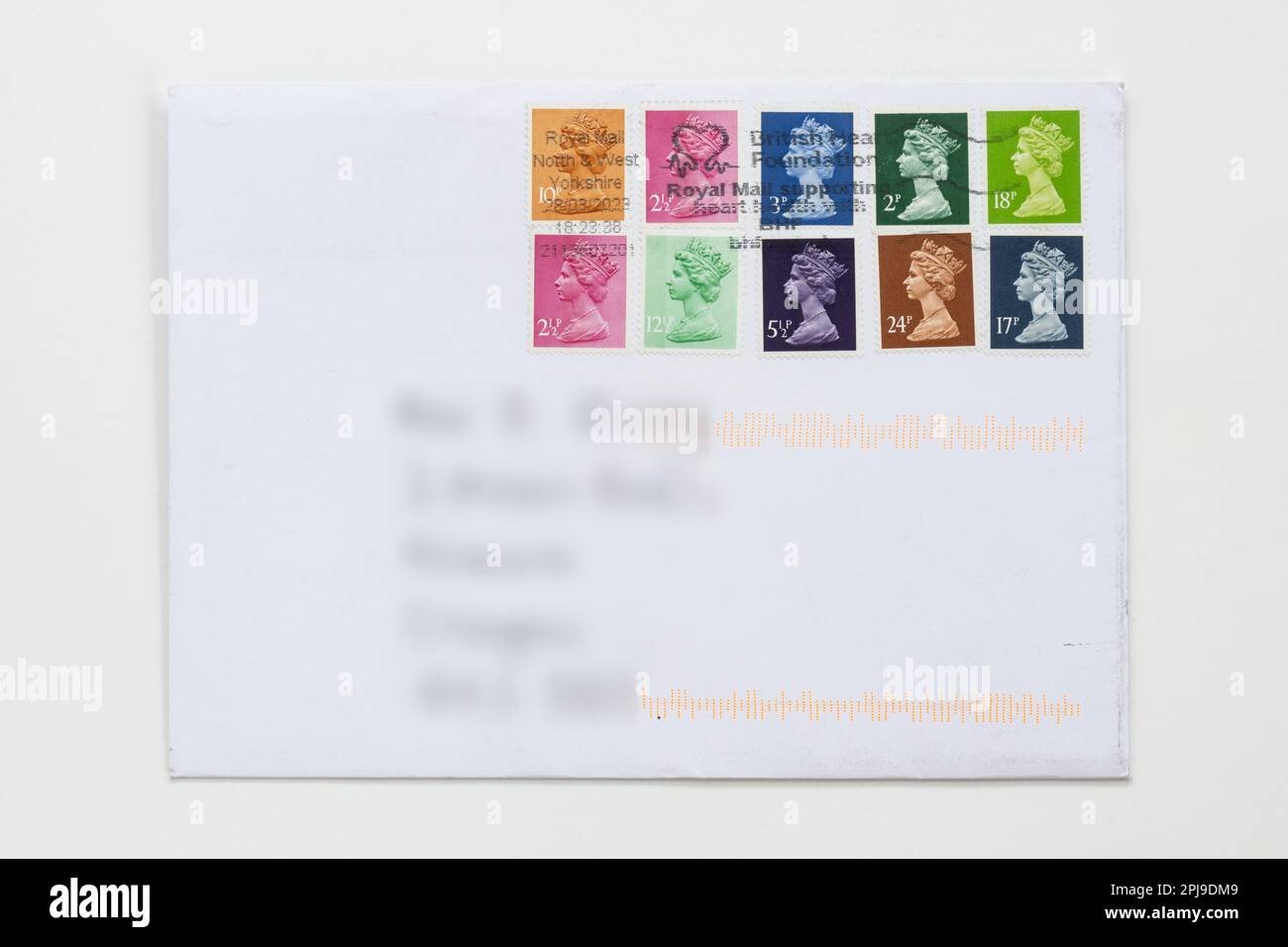 Using up old non-barcoded stamps during 6 month grace period to 31 July 2023 (post marked 28 March 2023) when only stamps with bar code can be used Stock Photo