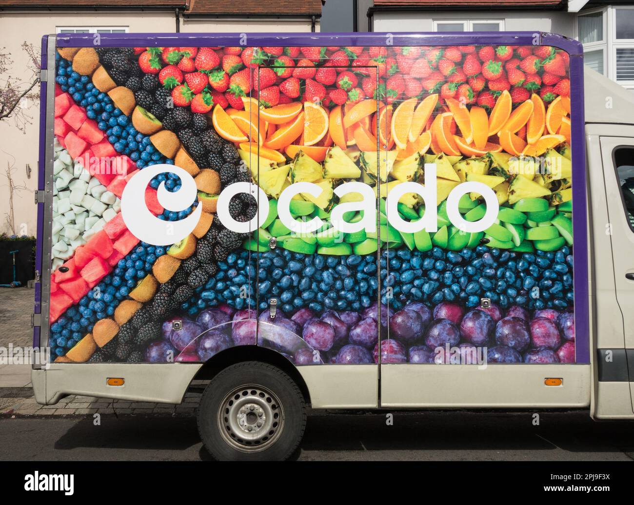 Closeup of fresh fruits on the side of an Ocado delivery van on a