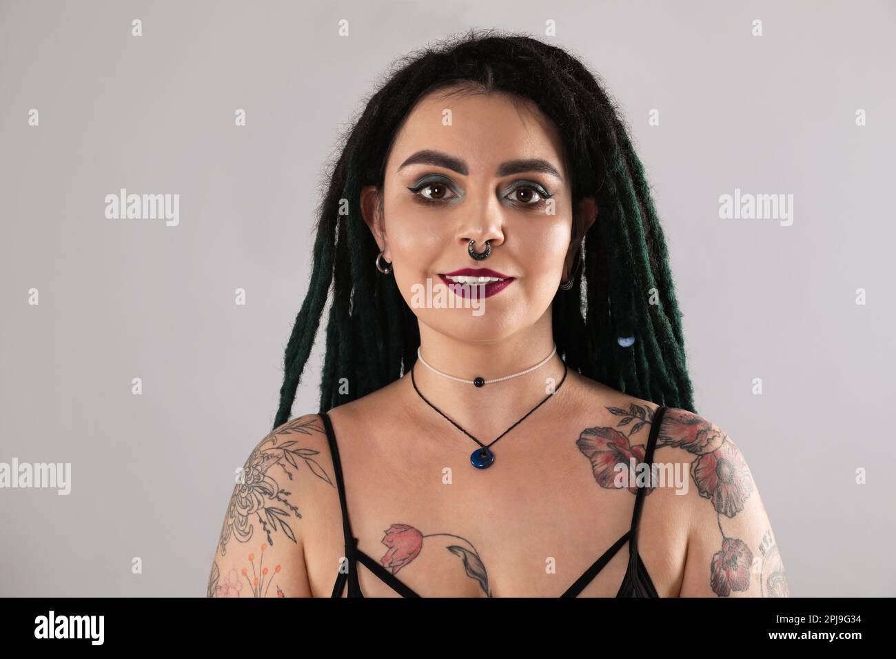 A Portrait of a Tattooed Woman with a Nose Piercing · Free Stock Photo