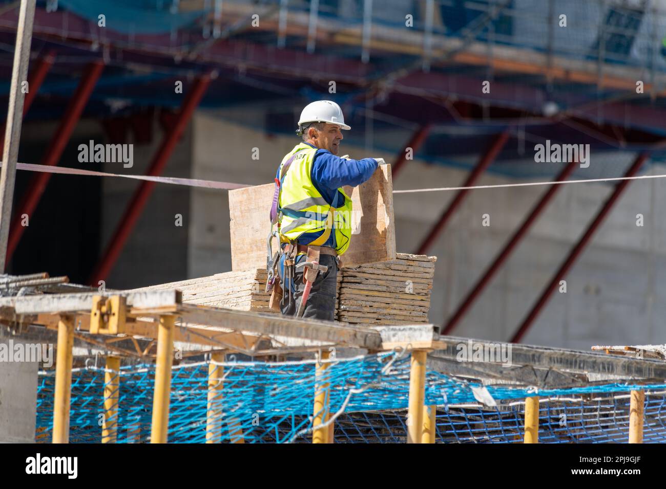 Labourer working on new modern highrise building, Spain Stock Photo
