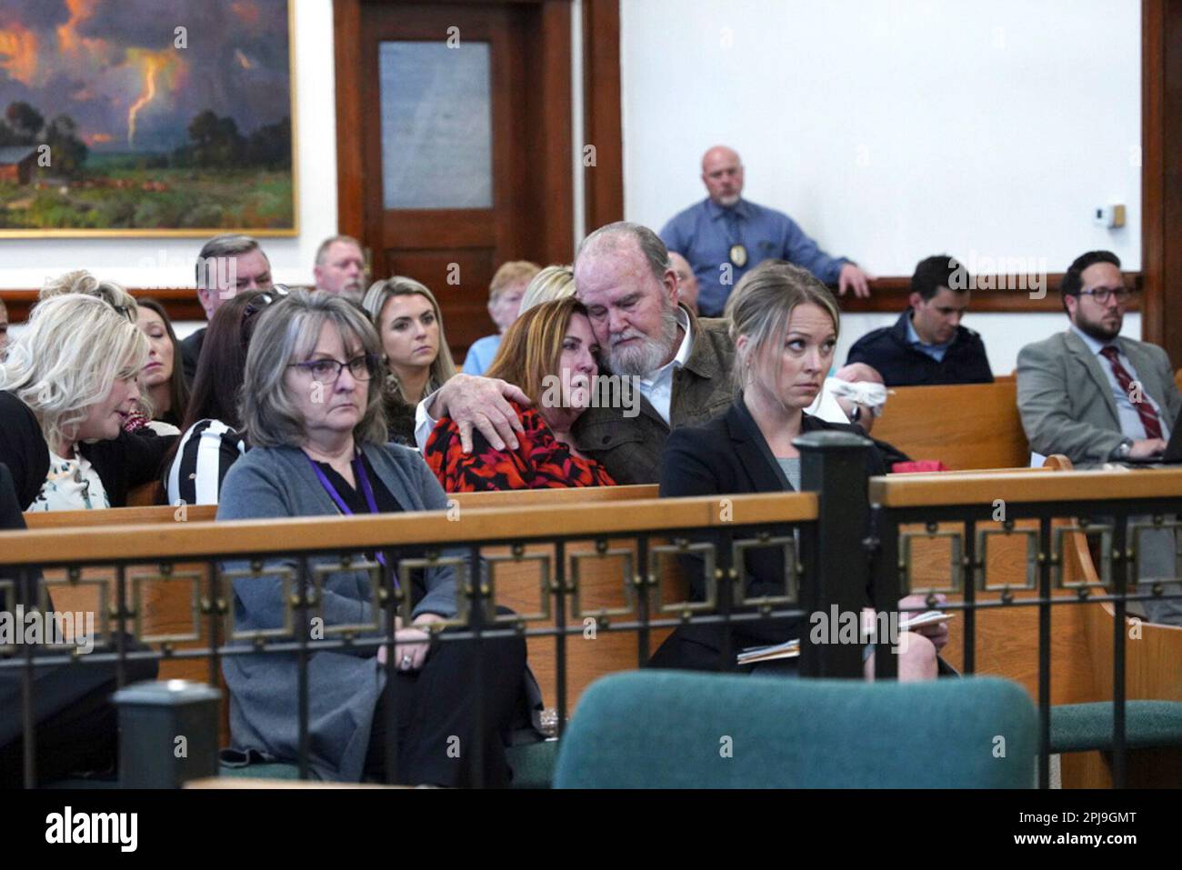 Larry and Kay Woodcock, center, grandparents of Joshua "JJ" Vallow, listen during a court