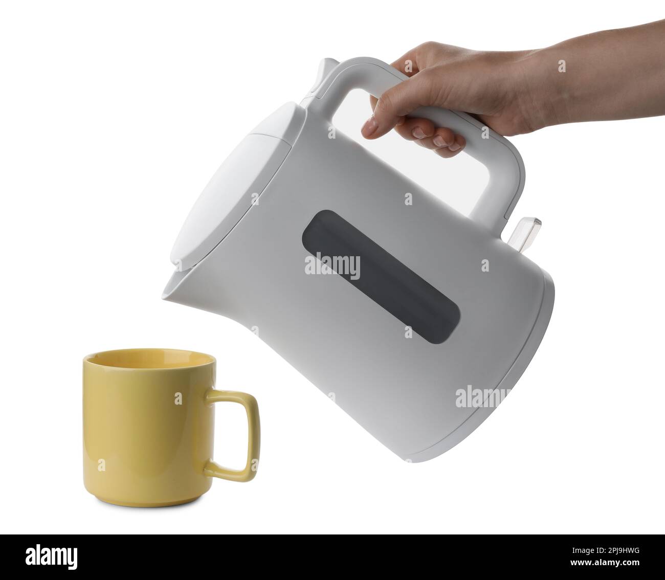 Woman pouring hot water from electric kettle into cup on white