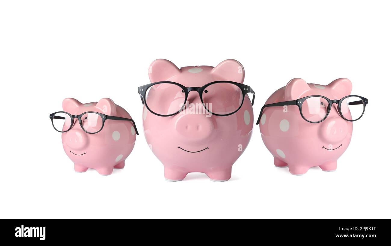 Pink ceramic piggy banks in glasses on white background Stock Photo - Alamy