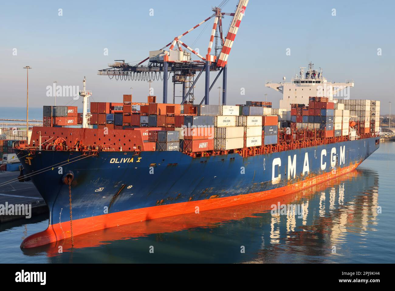 Livorno, Italy - 08 20 2023: Container terminal with stowed containers from different shippers gantry cranes and straddle carriers in Livorno. In hori Stock Photo