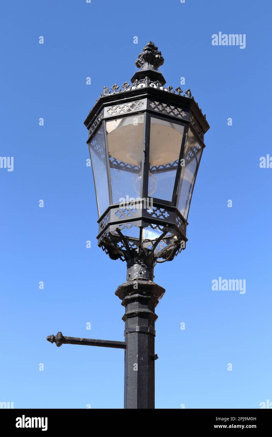 Victorian cast iron street light against a blue sky Stock Photo Alamy