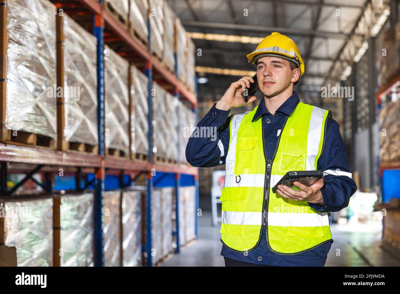 engineer worker using smartphone phone calling people in factory store ...