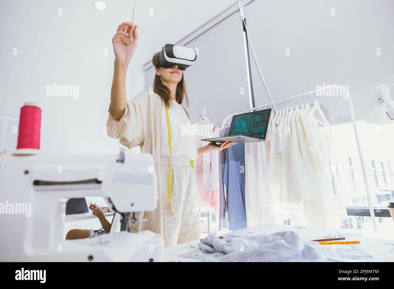Costume designer using modern VR visual digital design technology in tailor studio Stock Photo