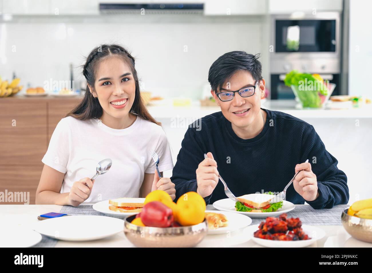 Portrait couple Asian man and woman enjoy eating healthy food. healthcare home family people. Stock Photo