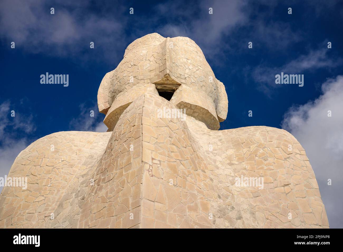 Stairwell topped with  wavy shapes and the 4-armed cross designed by Gaudí on the roof terrace of Casa Milà - La Pedrera. Barcelona, Catalonia, Spain Stock Photo