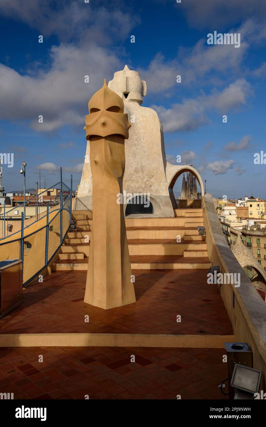 Rooftop chimneys of Casa Milà - La Pedrera with the Sagrada Familia in the background (Barcelona, Catalonia, Spain) ESP Chimeneas azotea de la Pedrera Stock Photo