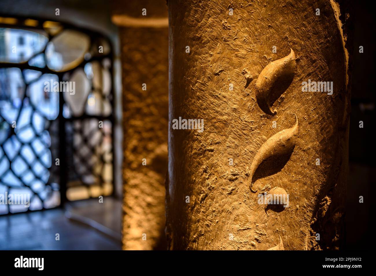 Shapes of leaves sculpted on a stone column on the access staircase to the noble floor of La Pedrera - Casa Milà (Barcelona, Catalonia, Spain) Stock Photo