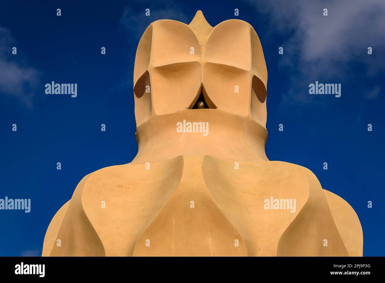 Stairwell topped with curved shapes and the 4-armed cross designed by Gaudí on the roof terrace of Casa Milà - La Pedrera. Barcelona Catalonia Spain Stock Photo