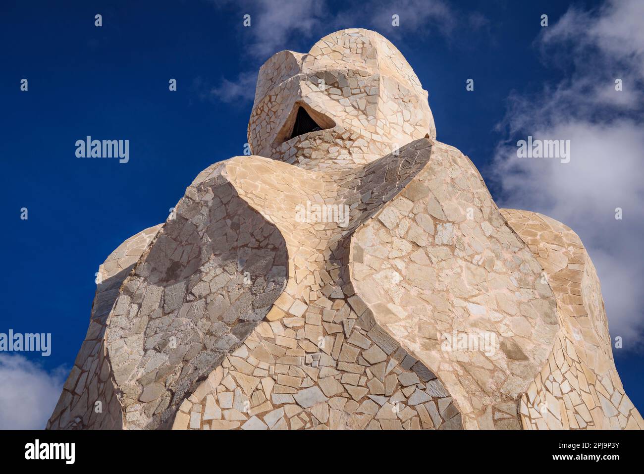 Stairwell topped with curved shapes and the 4-armed cross designed by Gaudí on the roof terrace of Casa Milà - La Pedrera. Barcelona Catalonia Spain Stock Photo