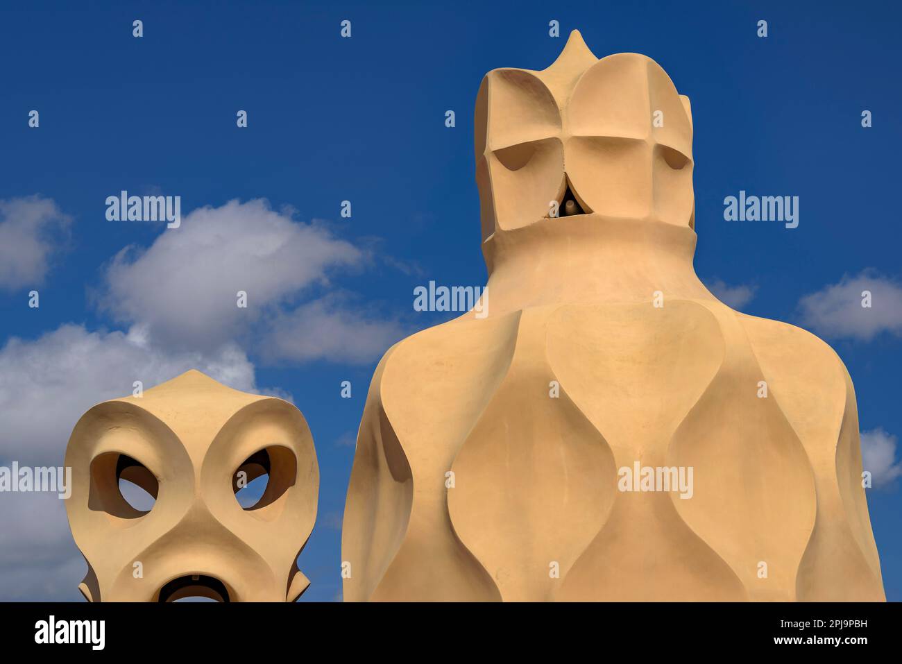 Stairwell topped with curved shapes and the 4-armed cross designed by Gaudí on the roof terrace of Casa Milà - La Pedrera, Barcelona Catalonia Spain Stock Photo