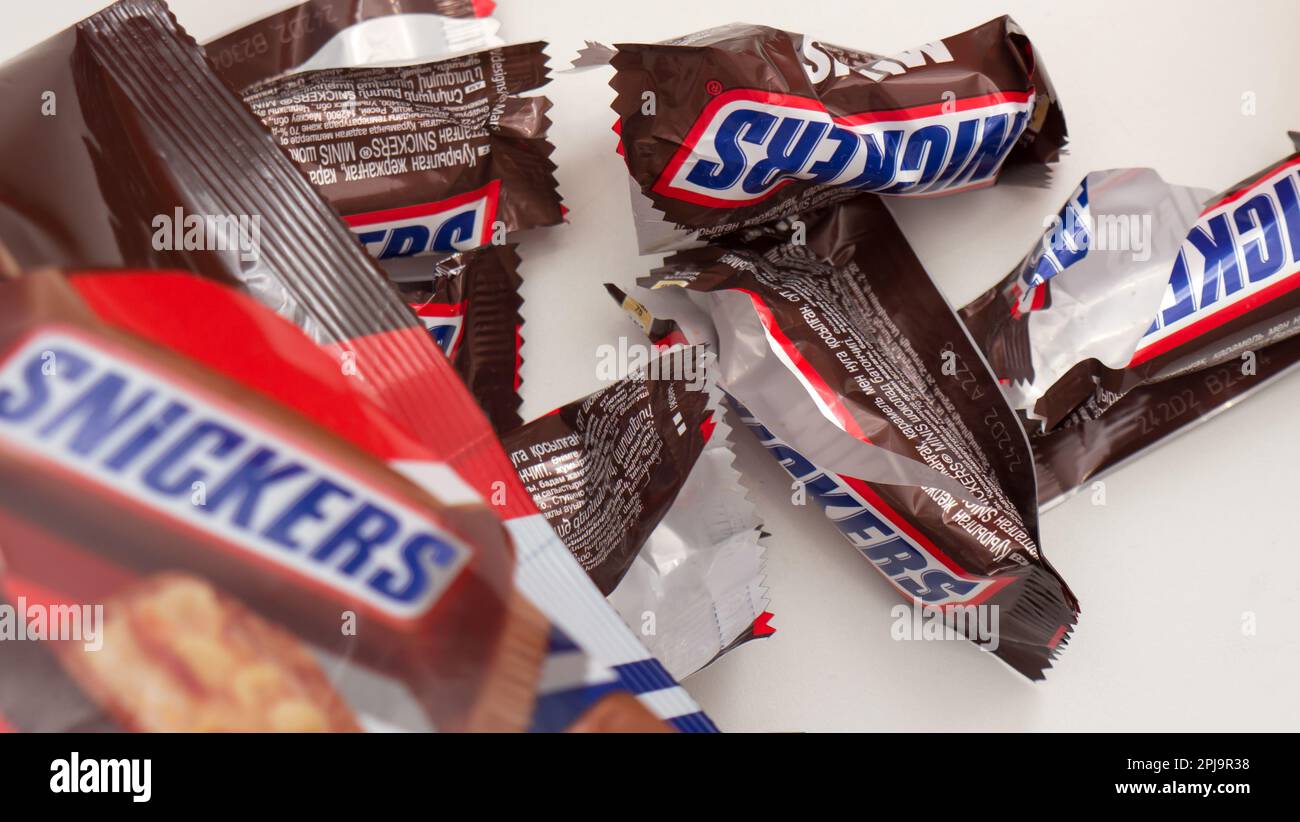 Сhocolate bar Snickers on a brown background. Stock Photo