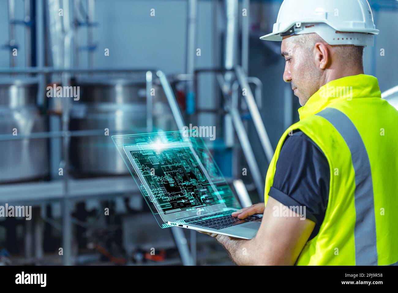 Smart engineer worker using software on laptop to monitor check factory boiler pipe valve control system Stock Photo